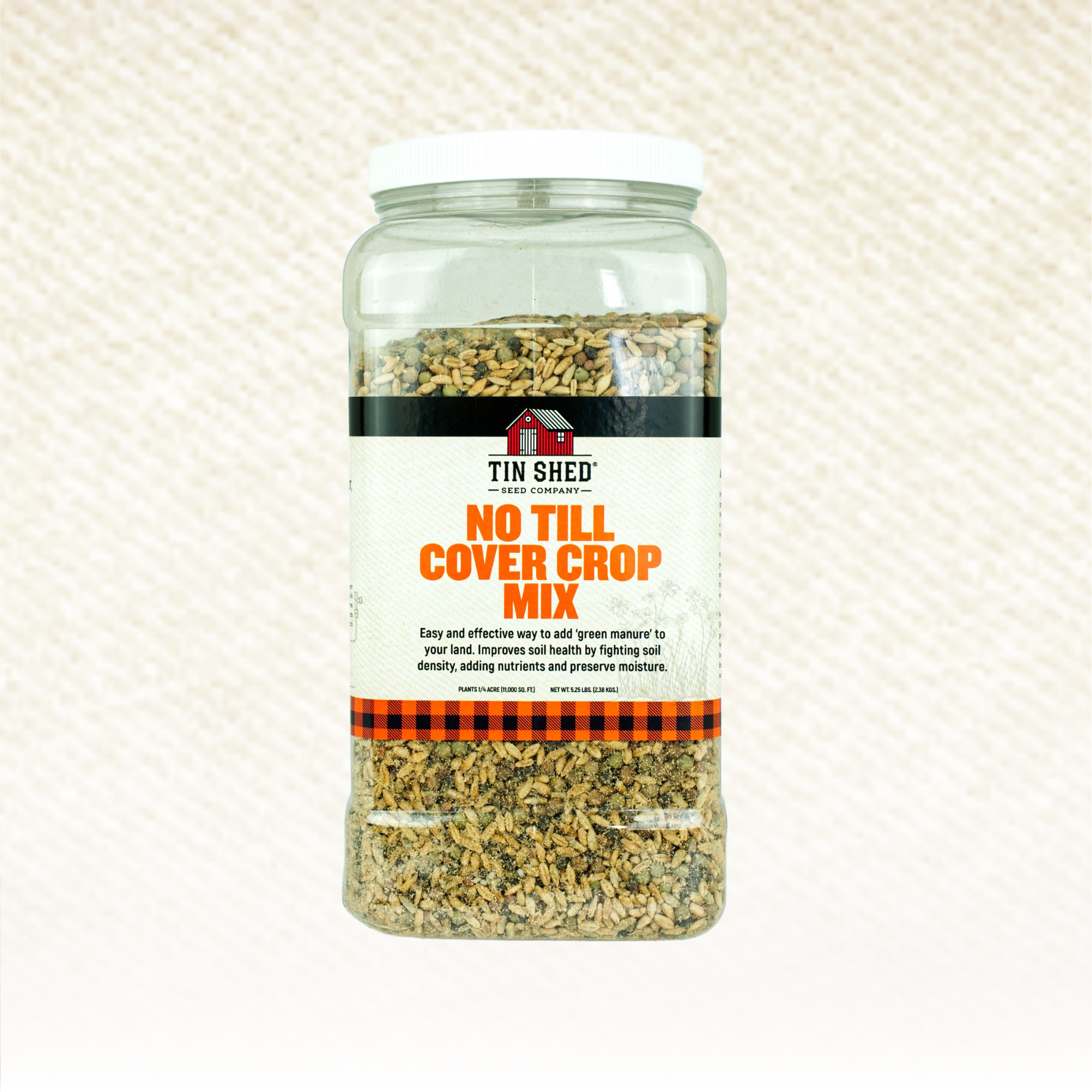 Jar of Tin Shed No Till Cover Crop Mix on a textured beige background