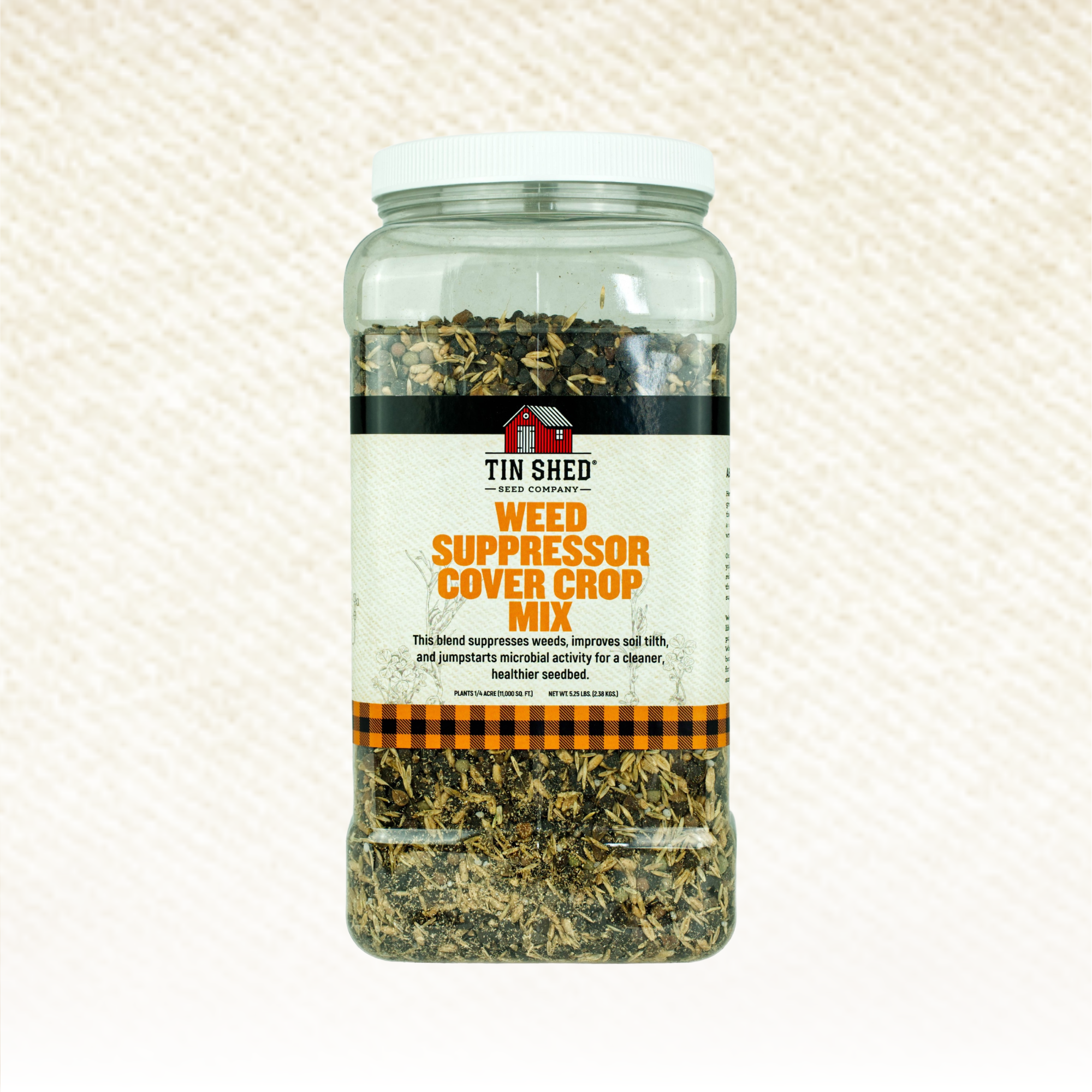 Jar of Tin Shed Weed Suppressor Cover Crop Mix on a textured beige background